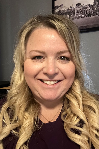 Smiling staff member in a close-up portrait.