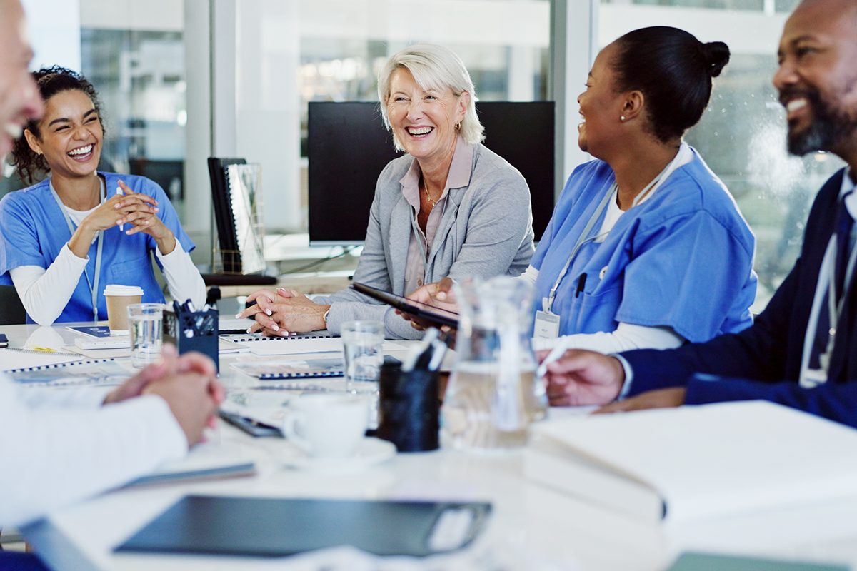 Group of caregivers laughing in a meeting