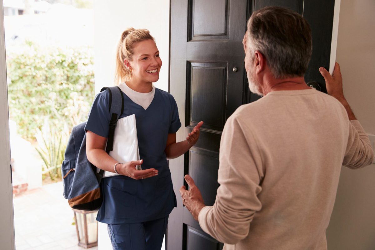 Staff member greeting a resident at the door