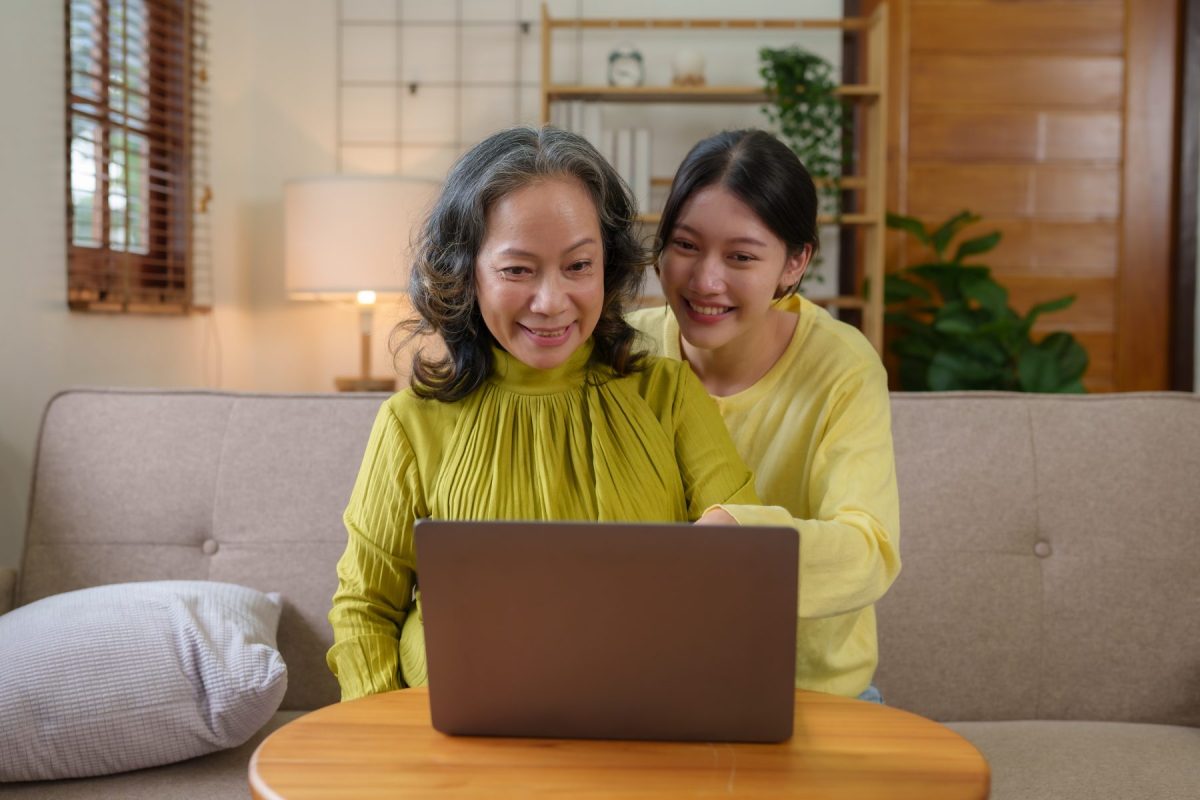 Senior woman using a laptop with a young woman