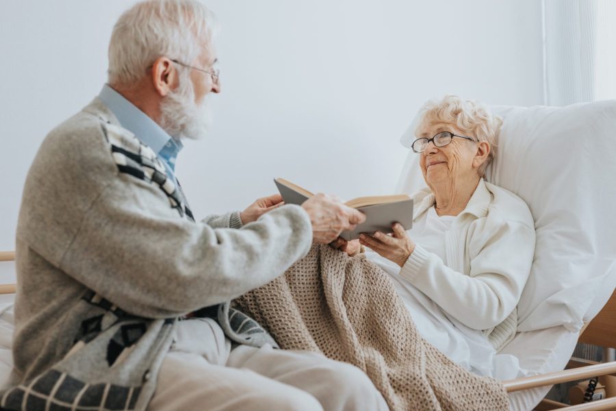 Elderly couple reading together in a cozy room.