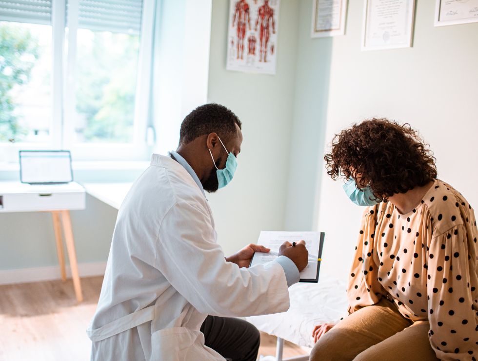 Healthcare professional consulting with a patient in an office.