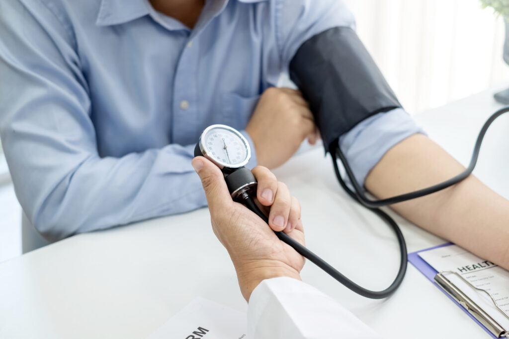Healthcare professional checking blood pressure