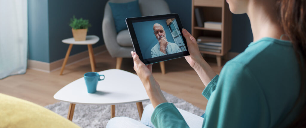 Resident engaging in a virtual consultation on a tablet.