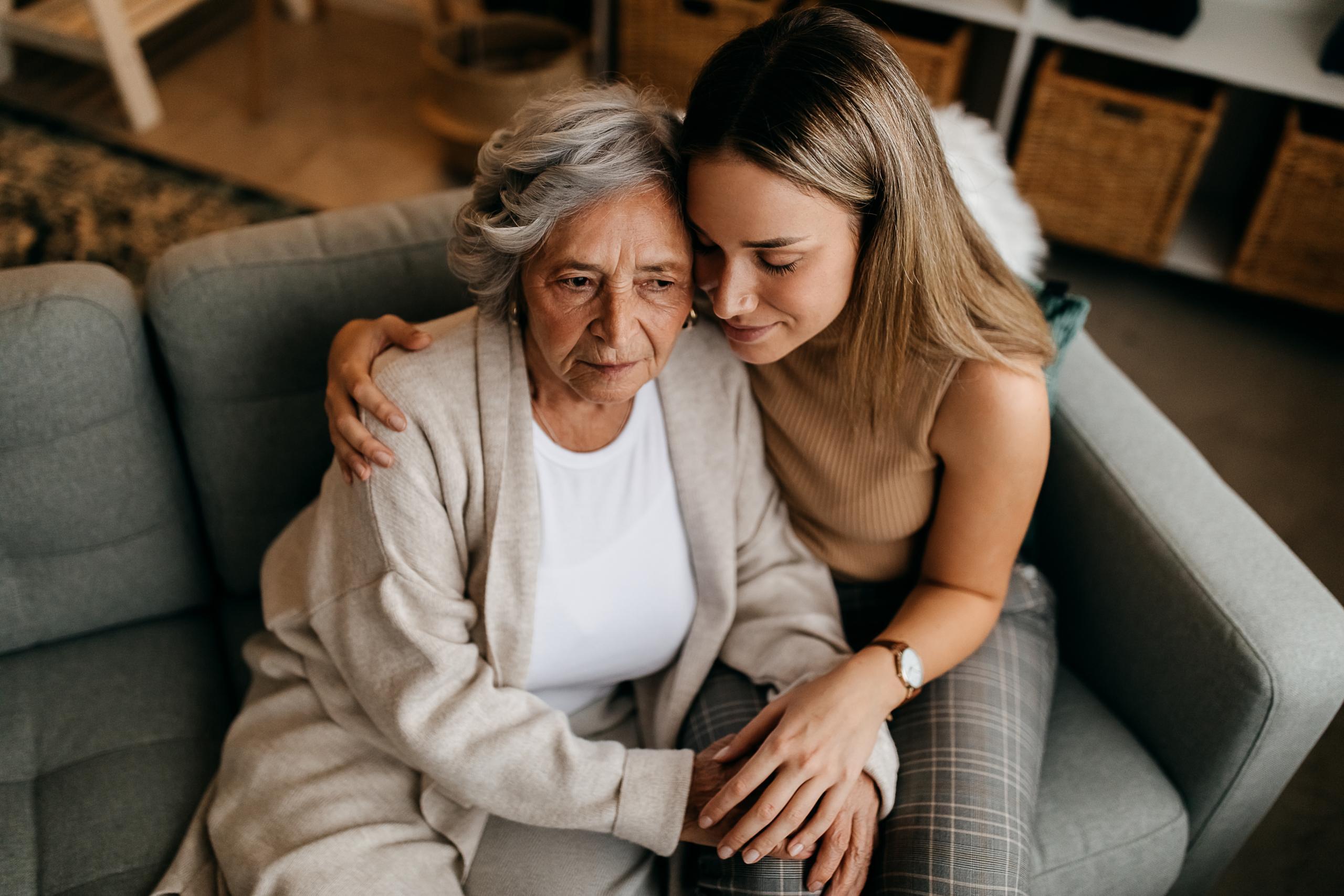 A caregiver and elderly woman sharing a moment together.