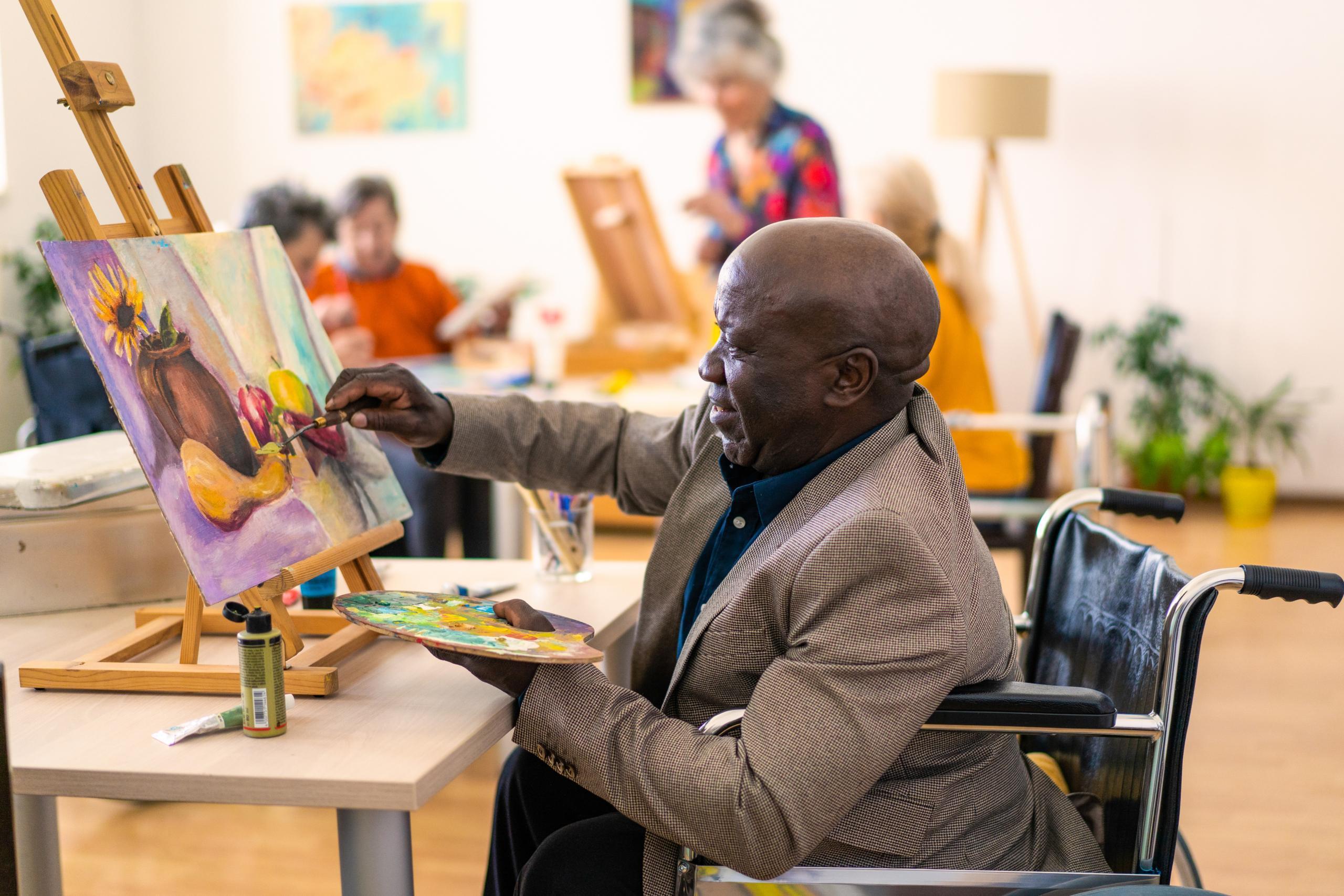 Resident painting in an art activity session