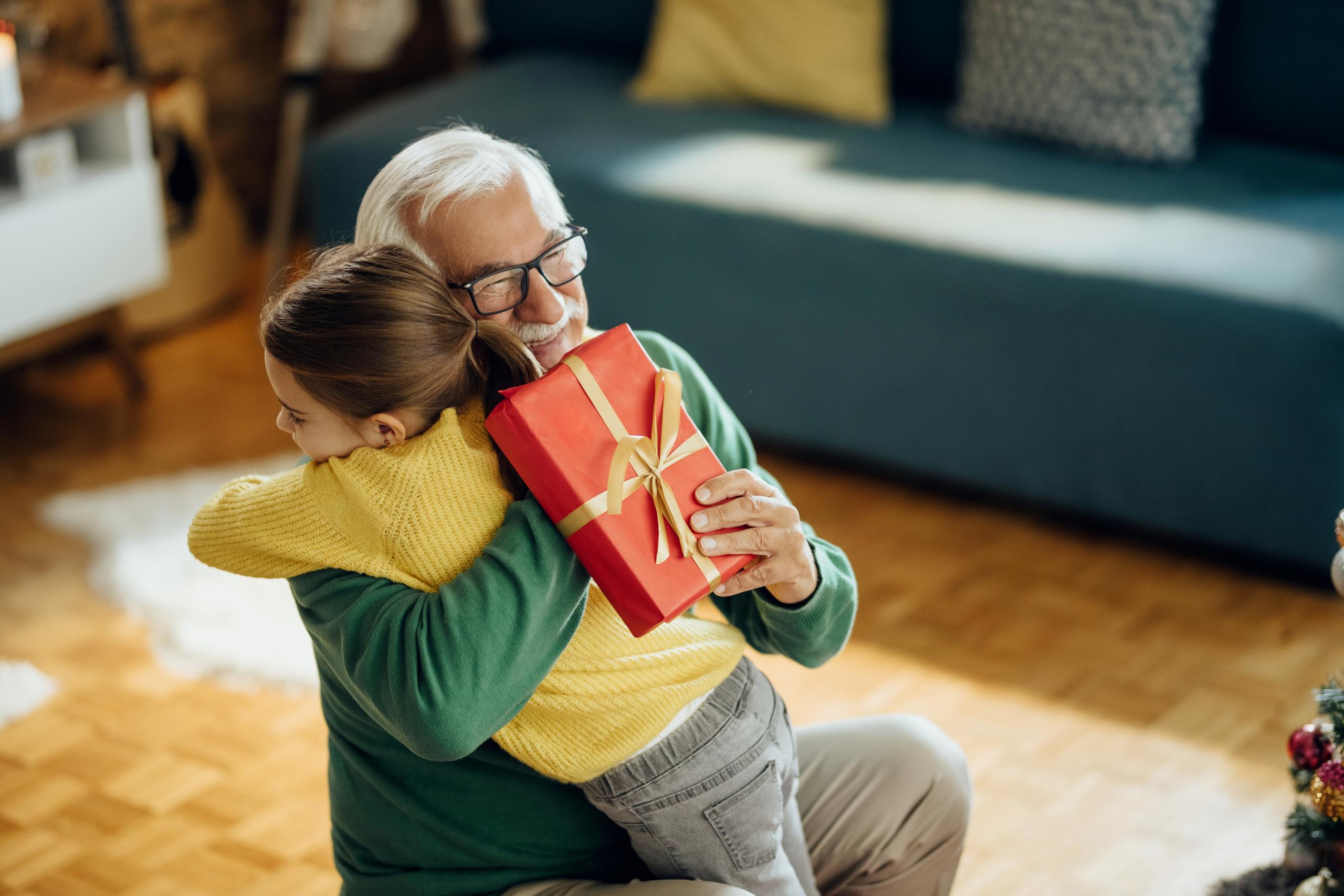 Senior man hugging a child in a cozy interior