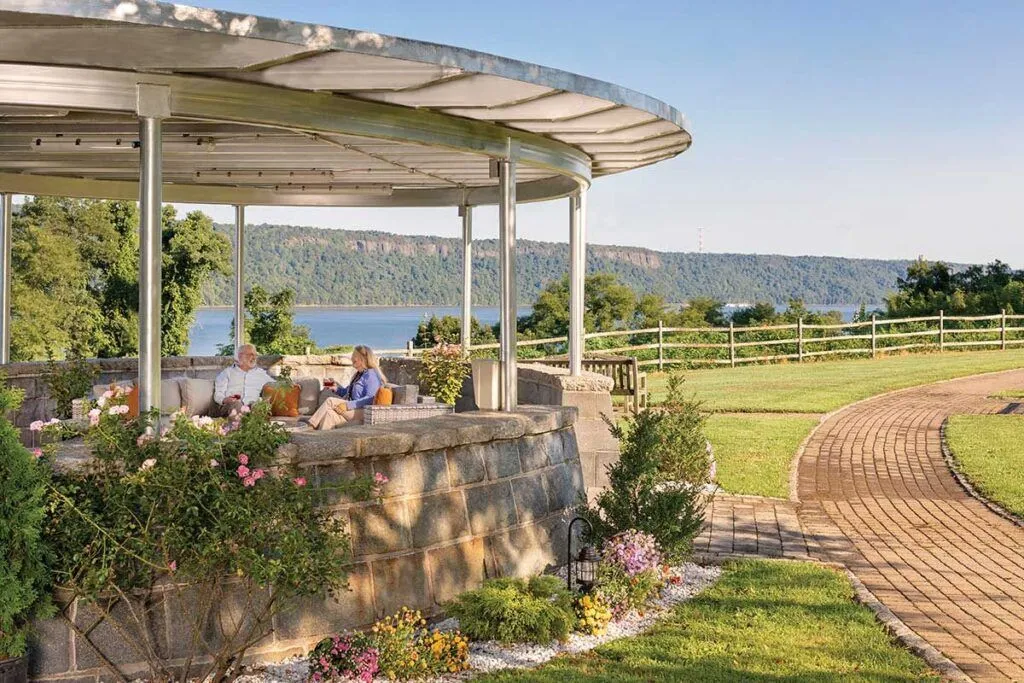 Residents relaxing in an outdoor space with a view.