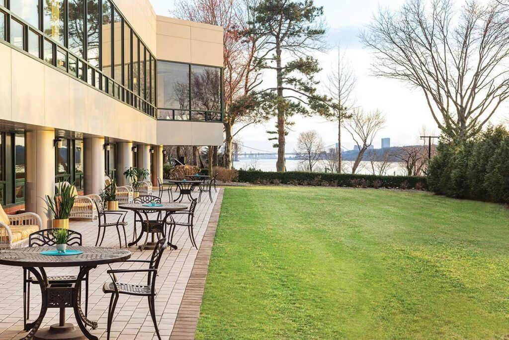 Lush outdoor space with seating and river view