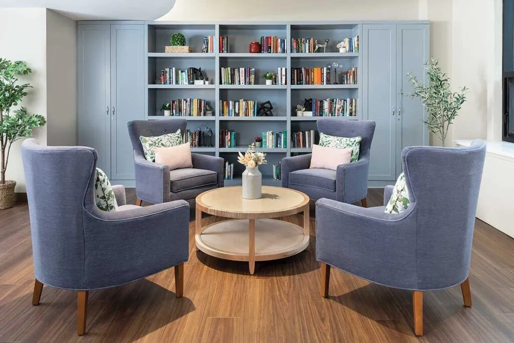 Cozy common area with seating and bookshelves