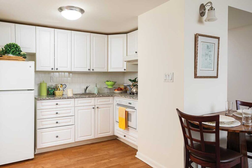 Bright kitchen area with dining table and appliances.