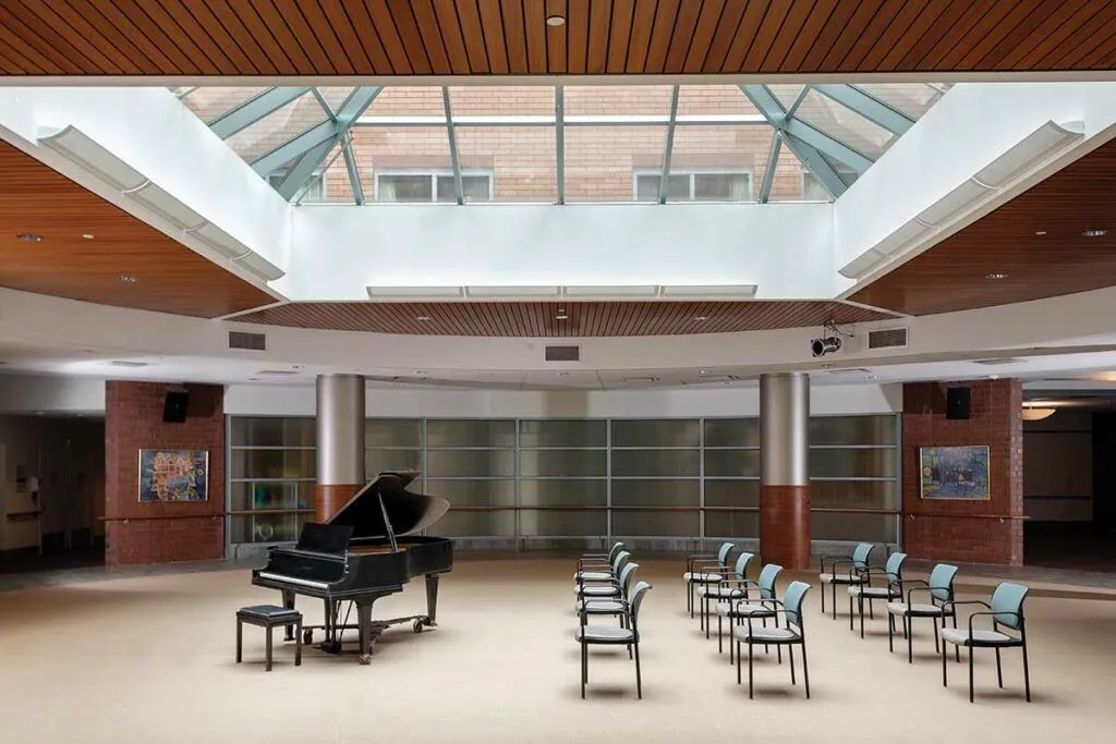 Interior view of a common area with a piano and chairs