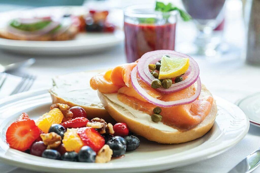A well-presented meal with salmon and fruits.