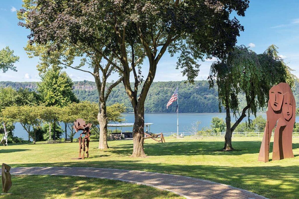 Outdoor space with sculptures and river view.