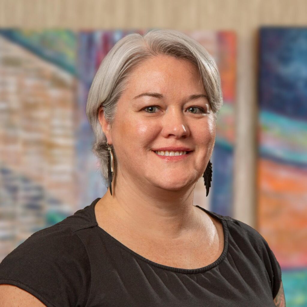 A staff member smiling indoors