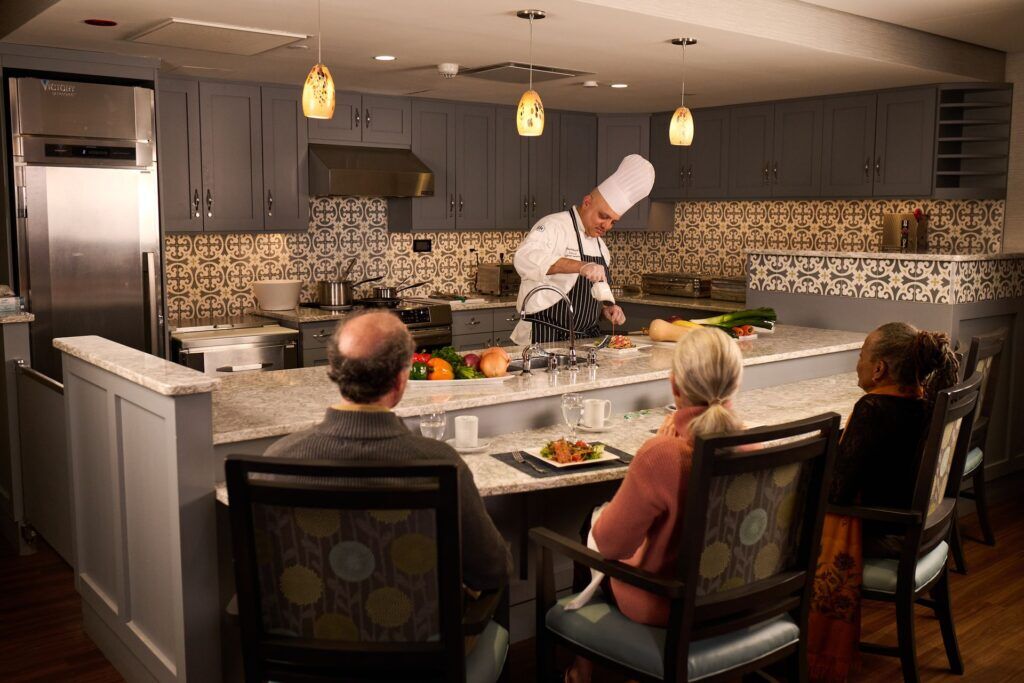 Chef preparing food for residents in a kitchen