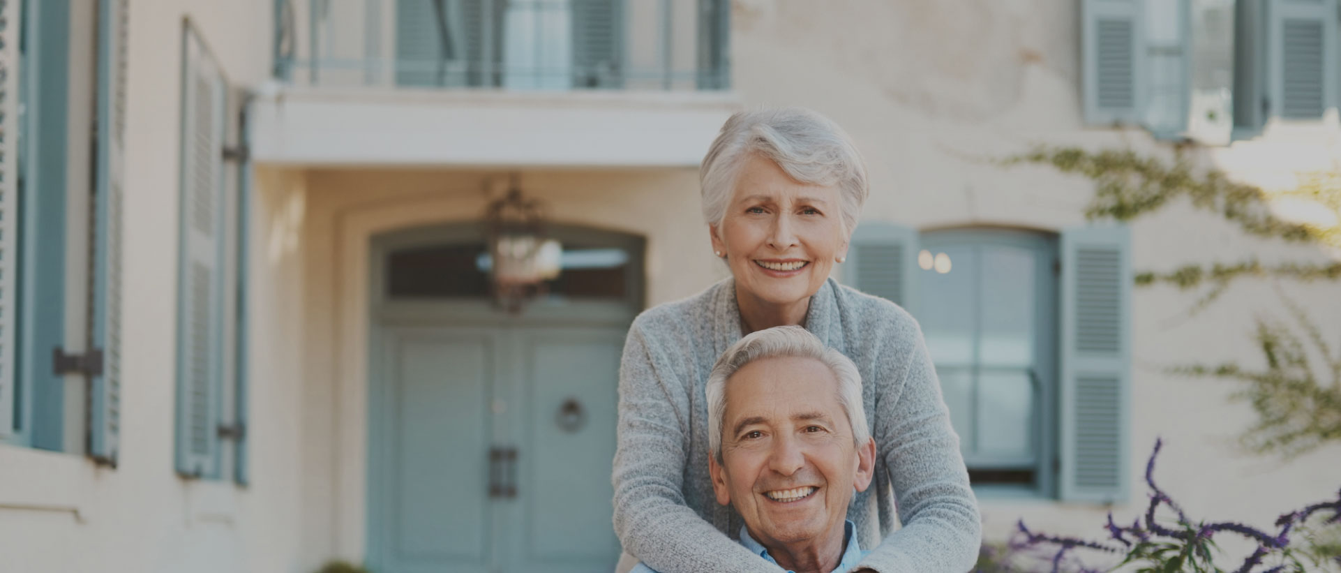 Elderly couple smiling together outdoors