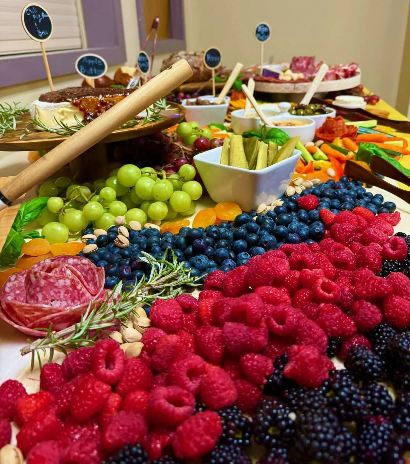 A beautifully arranged charcuterie board with fruits and snacks.