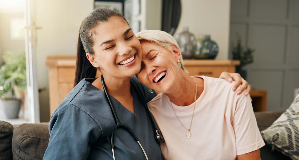 Caregiver and resident sharing a joyful moment.