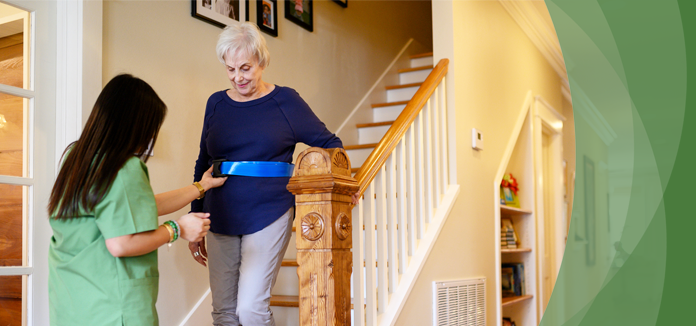 Staff assisting a resident on stairway.