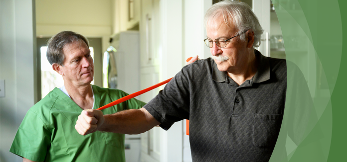 Therapist assisting senior with exercise