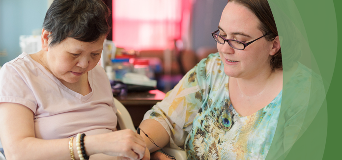 Caregiver assisting a resident with an activity.