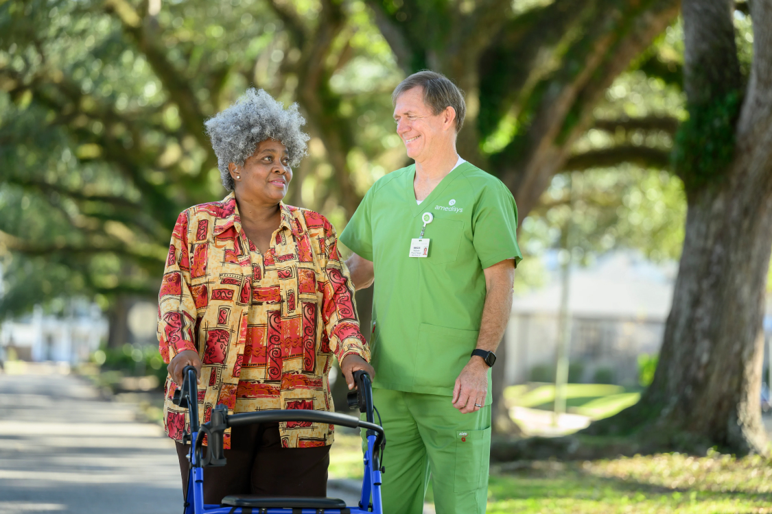 A staff member assisting a resident outdoors