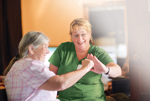 Staff interacting with a resident in a cozy setting.