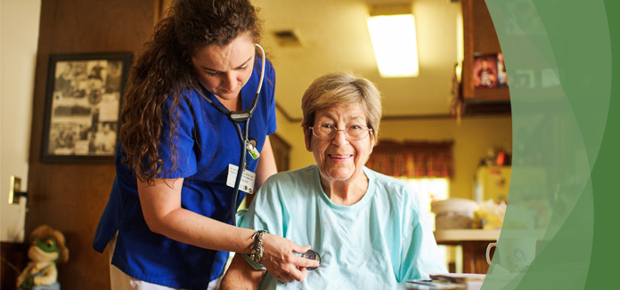 Nurse assisting a smiling resident in a cozy interior