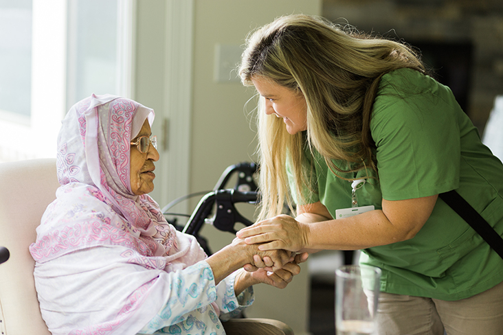 Staff member interacting with resident in a cozy setting