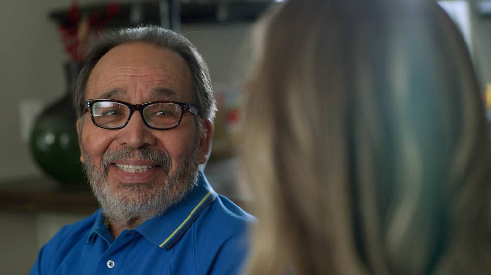 Senior man smiling during a conversation.