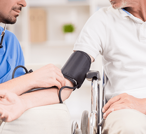 Nurse taking a blood pressure reading of a senior.