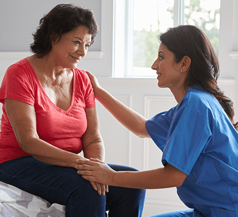 Caregiver interacting with a resident in a cozy interior