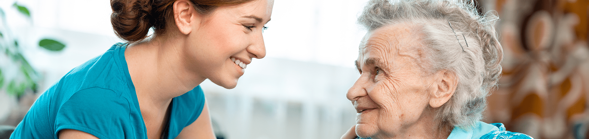 Caregiver interacting warmly with elderly resident