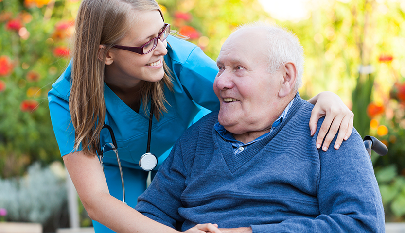 Caregiver interacting with a resident outdoors