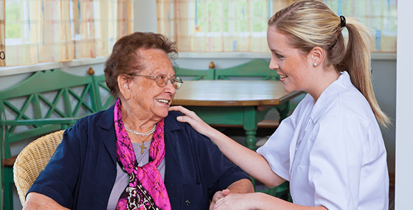 Caregiver interacting with a senior resident.