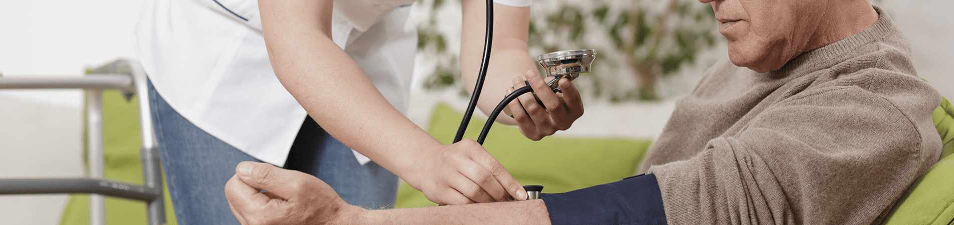 Nurse checking blood pressure of senior man