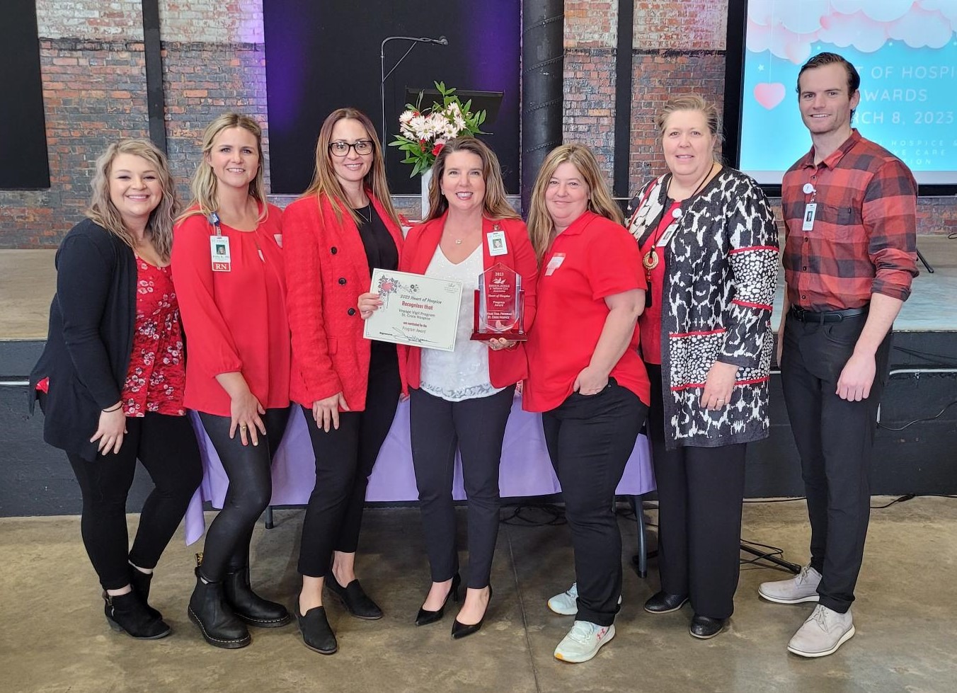Staff celebrating an award at an event.