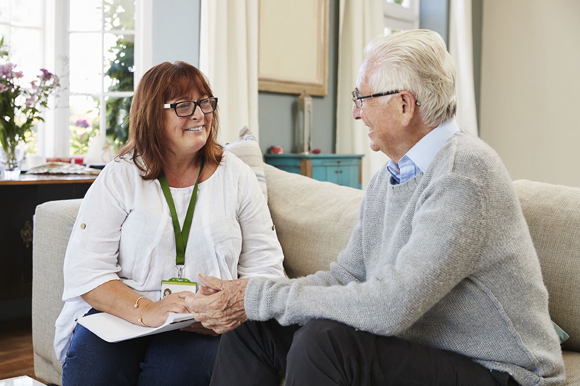 Staff speaking with a resident in a cozy interior
