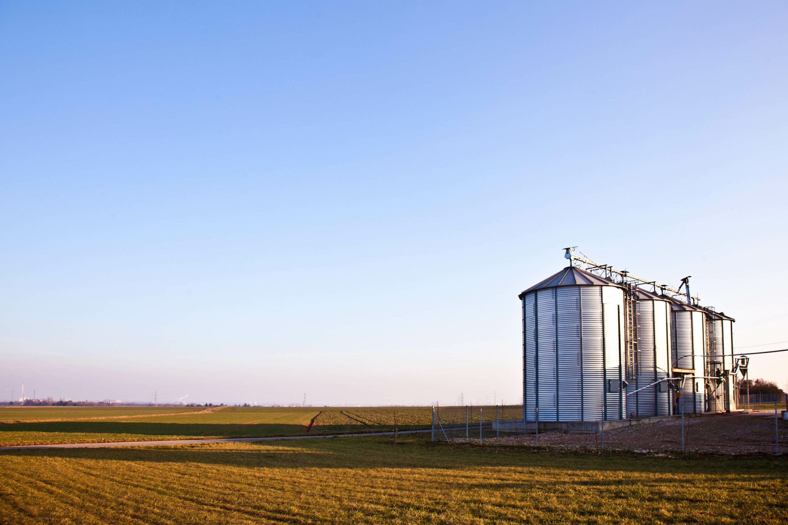 Metal silos in a rural landscape