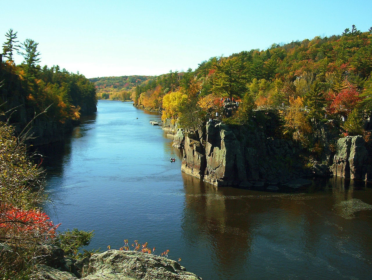 Scenic view of a river surrounded by autumn foliage.