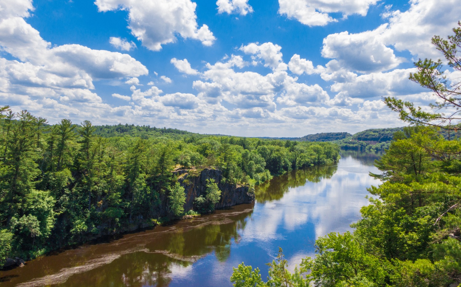 Scenic view of a river surrounded by greenery.