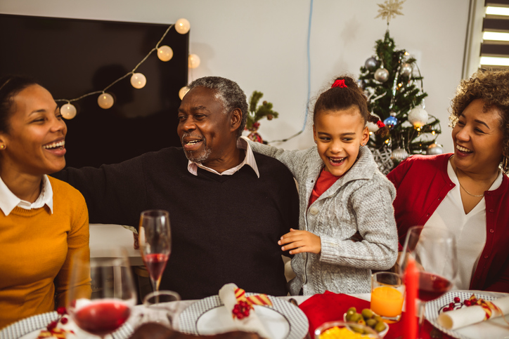 Family gathering around a festive dining table.