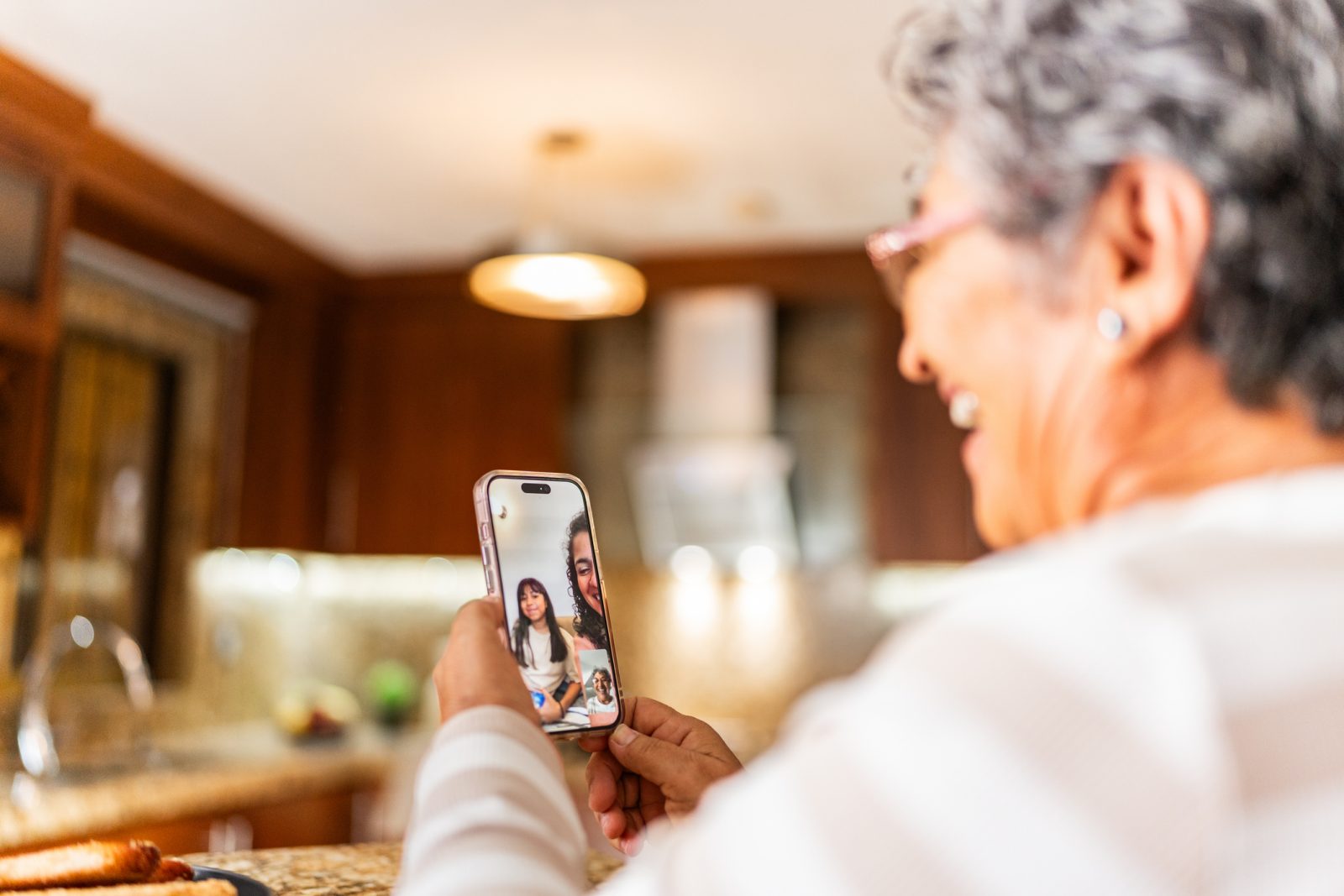 Senior woman enjoying a video call in a kitchen