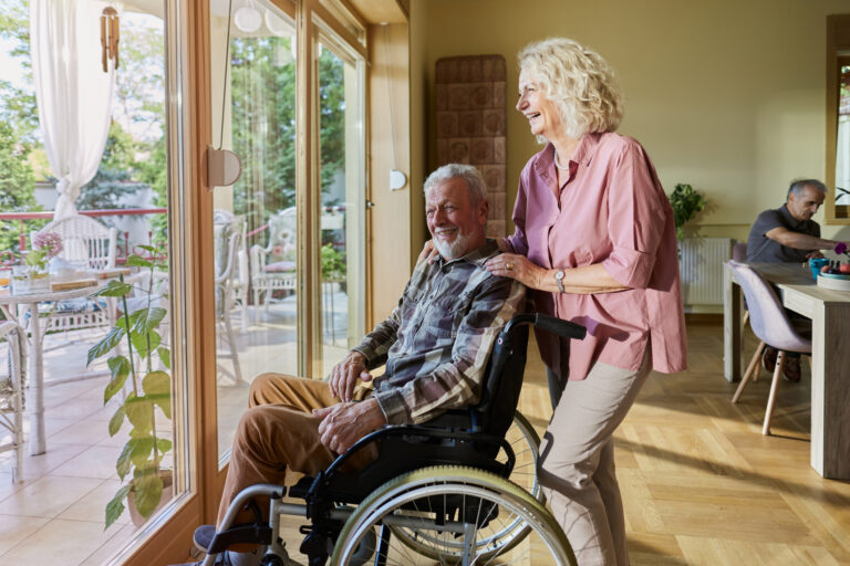 Happy interaction between a resident and staff member indoors