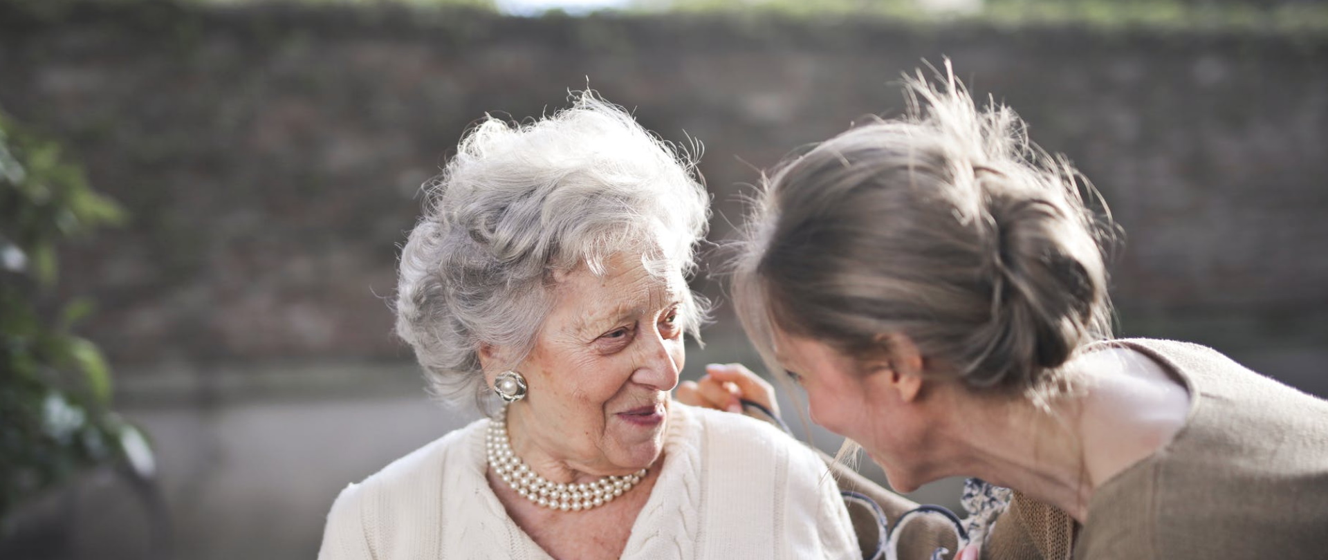 Senior resident interacting joyfully with staff member.