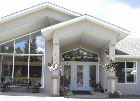 Entrance of Carefree Manor with flower decorations.