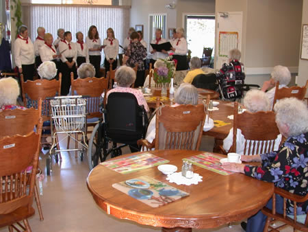 Residents enjoying a performance in a common area.