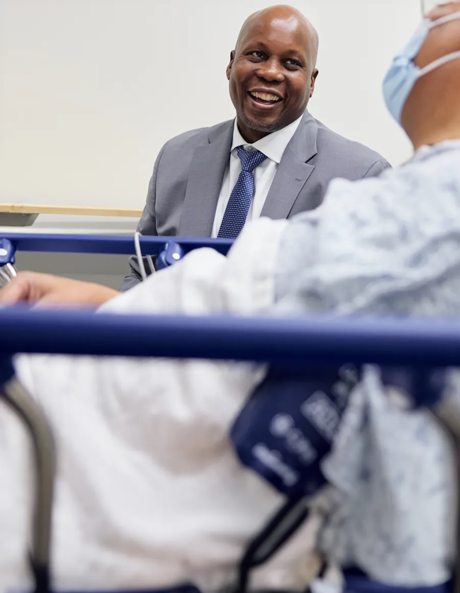 Smiling healthcare professional interacting with a patient.