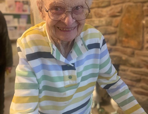 Elderly woman smiling in a care facility